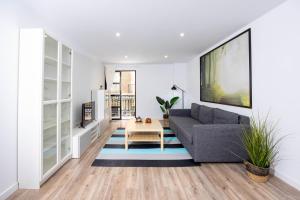 a living room with a couch and a table at Apartamentos Turísticos Puerto Cartago by CartagenaSpain in Cartagena