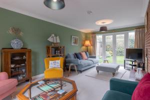 a living room with a couch and a table at Buntings in Walberswick