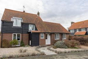 a house with a black and red roof at Buntings in Walberswick