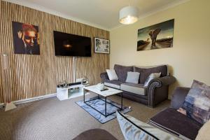 a living room with a couch and a table at Stylish 1-Bed Apartment in Manchester