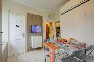 a kitchen and dining room with a table and chairs at Aton House - Happy Rentals in Manerba del Garda