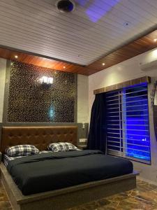 a bedroom with a bed in a room with a window at Imagine star in Lonavala
