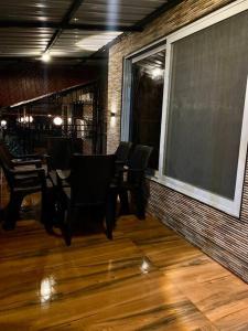 a dining room with black chairs and a large window at Imagine star in Lonavala