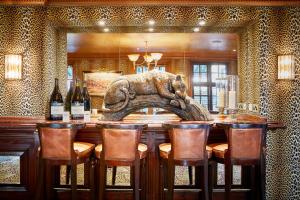 a dining room with a table with bottles of wine at The Montague On The Gardens in London