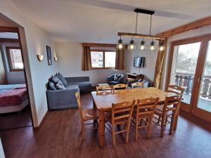a dining room and living room with a table and chairs at Pracondu OUTDOOR & FUN appartement 8 personnes by Alpvision Résidences in Nendaz