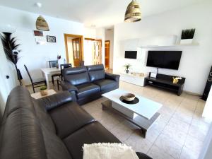a living room with a couch and a tv at Villas Rodríguez in Playa Blanca