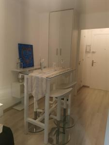 a kitchen with a white table with a white table cloth at JIMMYS HOUSE 55 in Beausoleil