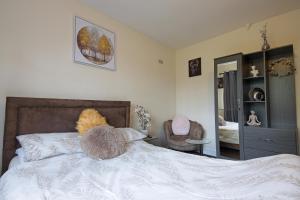 a bedroom with a bed with a stuffed animal on it at Stylish 1-Bed Apartment in Manchester