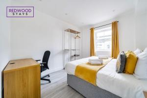 a bedroom with a bed with a desk and a chair at BRAND NEW, 2 Bed 1 Bath, Modern Town Center Apartment, FREE WiFi & Netflix By REDWOOD STAYS in Aldershot