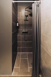 a shower with a shower curtain in a bathroom at Brim Hotel in Reykjavík