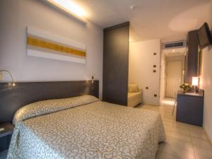 a bedroom with a large bed in a room at Dante Family Beach Resort in Cervia