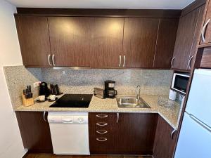 a kitchen with wooden cabinets and a counter top at Frontera Blanca Premium in Pas de la Casa