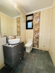 a bathroom with a sink and a toilet in it at Hotel Airport Stay - Near Terminal 3 in New Delhi