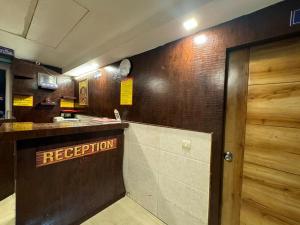 a restaurant with a reception counter and a door at Hotel Airport Stay - Near Terminal 3 in New Delhi