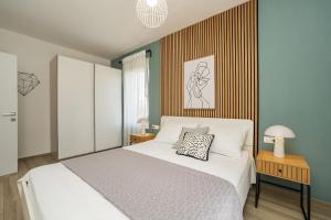 a bedroom with a white bed and a wooden wall at Luxury Home Polo in Bibinje
