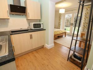 a kitchen with a microwave on top of a counter at Woodland View in Bishop Auckland