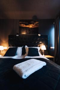 a bedroom with a large bed with a white blanket on it at Brim Hotel in Reykjavík