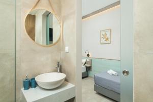 a bathroom with a sink and a mirror at Stefanie Studios in Agia Marina Nea Kydonias