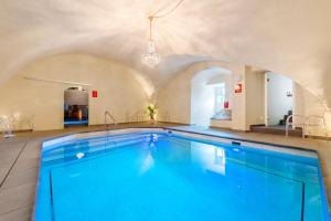 a swimming pool in a large room with a ceiling at Schloss Purschenstein in Neuhausen