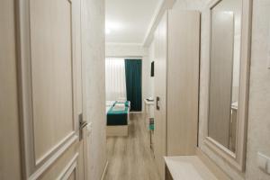 a bathroom with a door leading to a room at HOTEL MERCURI-MERIDIAN in Bukhara