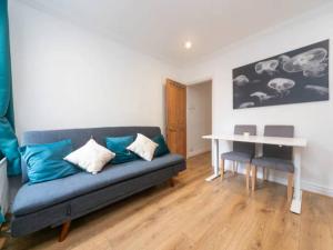 a living room with a couch and a table at Charming Period Home near Surbiton with Garden in London