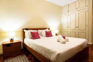 Un dormitorio con una cama grande con almohadas rojas. en GuestReady - Family-Friendly Haven in Funchal, en Funchal