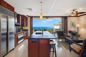 a kitchen with a view of the ocean at Ko Olina Beach Villas O805 in Kapolei