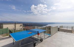 a blue ping pong table on the balcony of a house at Gorgeous Apartment In Bregi With Sauna in Breza