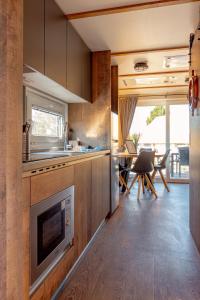 a kitchen with a sink and a stove at Mobilheim Kaperfahrt in Großenbrode