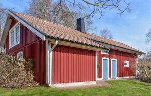 a red barn with a red roof at Lovely Apartment In Markaryd With Lake View in Markaryd