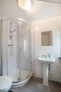 a bathroom with a shower and a sink at 4Bedrooms-Free Parking-6 Beds in Manchester