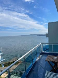 a balcony with a view of the ocean at Апартамент Лариди in Sozopol