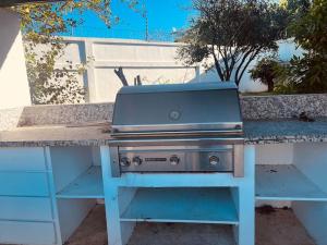 a blue grill sitting on top of a table at Hacienda Ortiz: Luxury Space. in Matanzas