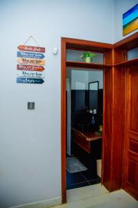 a door leading into a bathroom with a mirror at Casablanca in Kigali in Kigali