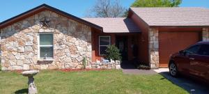 a stone house with a car parked in front of it at Vanessa rooms in Harker Heights