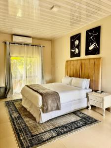 Un dormitorio con una cama grande y una ventana en Kaya Apartments 2 en Lusaka