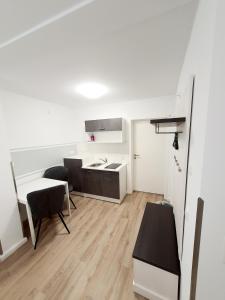 a room with a kitchen and a table and chairs at Pension Apostel in Wismar