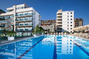 a large swimming pool in front of a building at Residence Atlantico in Lido di Jesolo