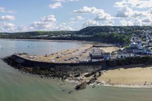 an aerial view of a beach with cars parked at Caerhafod Nanternis in Llanllwchaiarn
