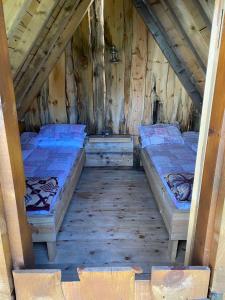 a room with two beds in a wooden cabin at EKO KAMP „LUKE“ in Nikšić