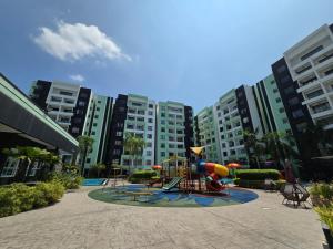 a playground in the middle of a city with tall buildings at Manhattan Condomium Water Park Land @ Ipoh in Ipoh