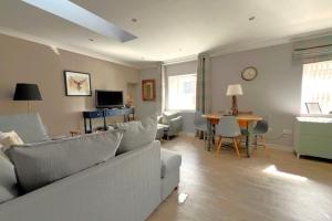 a living room with a couch and a table at Thistle Apartment in Golspie