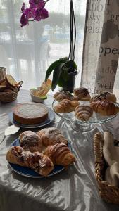 a table topped with plates of pastries and pies at Villa Zagara in Marsala