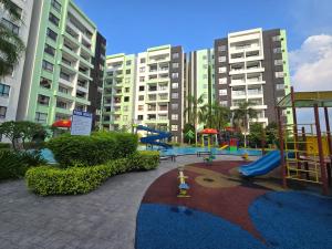a playground in front of some tall buildings at Manhattan Condomium Water Park Land @ Ipoh in Ipoh