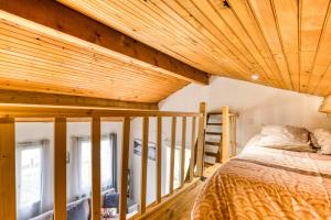 a bedroom with a bed and a wooden ceiling at Maison de Campagne in Gignac
