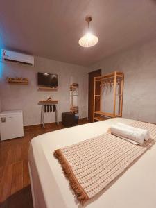 a bedroom with a bed with a rug on it at Martinelli Residence in Fernando de Noronha