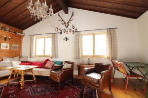 a living room with a couch and a table and chairs at Haus Haemmerle mit Ski in - Ski out in Damuls