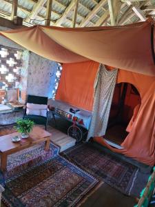 Zelt in einem Zimmer mit Teppichen und einem Tisch in der Unterkunft Nomads House in Bled