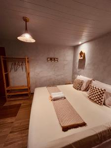 a bedroom with a large bed with a light at Martinelli Residence in Fernando de Noronha