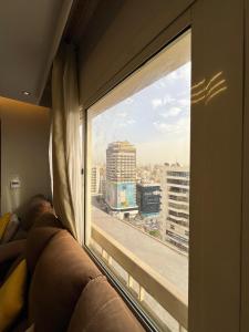 a man laying on a couch looking out a window at المهندسين جزيره العرب in Cairo